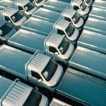 Duża flota białych pickupów zaparkowanych w równych rzędach z lotu ptaka